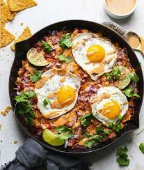 Chilaquiles With Fried Eggs And Tahini Chipotle Lime Crema Soom Foods Chilaquiles Recipe Red Chilaquiles Recipe Easy Red Chilaquiles Recipe