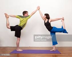 A Male And Female Yoga Instructor Practice Partner Yoga In The Studio Partner Yoga Partner Yoga Poses Yoga