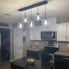 It blends industrial and farmhouse style making it a versatile fixture as accent lighting over a kitchen island or as a dining light over a smaller table. Mercury Row Yearwood 5 Light Cluster Globe Pendant Reviews Wayfair Globe Pendant Kitchen Remodel Lights Over Island
