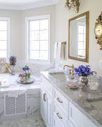 This serene bathroom has french details with the white cabinets, pale yellow wallpaper, and clean and feminine styling. 23 French Country Bathroom Decor Ideas For Your Home