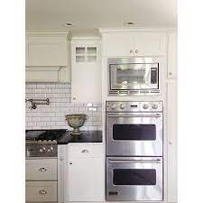 Mountain magic in highlands, north carolina cottage exterior, farmhouse exterior, mountain cottage. House Collected On Instagram Sneak Peek From A Favorite Remodel Project Whitekitche White Kitchen White Subway Tile Kitchen White Tile Kitchen Backsplash