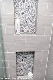 Two Shower Nooks With Marble Pebbles And Horizontal Grey Porcelain Tiles Modern Bathroom Renovation Modern Bathroom Renovations Shower Nook Shower Remodel