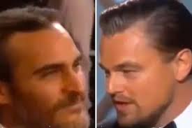 Golden Globes 2014: Joaquin Phoenix looks miserable as Leonardo DiCaprio  accepts his award for Best Actor