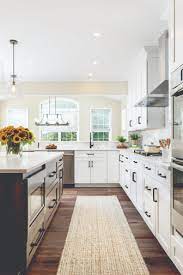 White shaker kitchen cabinets paired with black kitchen island. Trends We Love White Cabinets Black Hardware Wellborn Cabinet
