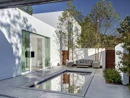 Walls of glass, windows and a tropical setting with a pool. Small Courtyard Swimming Pool Home Courtyard Design Courtyard House Modern Courtyard
