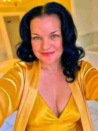 Basset hound destroying oven mitt