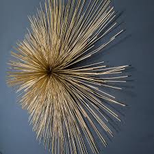 Hang multiples for a unique wall scape. Gold Sunburst Wall Art Audenza