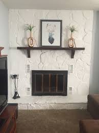 .it was a commitment! used plastic and painter's tape to protect the black firebox and along floor. Painted Rock Fireplace Gives The Lava Rock A Whole New Look Lava Rock Fireplace Remodel Painted Rock Fireplaces Farmhouse Fireplace Decor