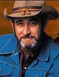 A dirt road sunset, a historic church, and a cow having some lunch all