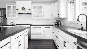 Splashes of vigorous color prevent the room from feeling monotonous. White Kitchen Cabinets With Black Countertops Walls And Floor Colors Backsplash Ideas