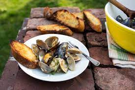 Grilled Clams And Mussels With Garlic Almonds And Mint Recipe Grilled Clams Mussels Seafood Recipes