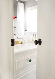 If the paint doesn't fall off by itself, scrub lightly with a stiff plastic brush. How To Upgrade Your Old Brass Door Knobs With Spray Paint Young House Love