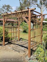 The traditional lattice detail supports climbing plants and flowers to provide a charming accent to any yard, garden, or pathway. Garden Arbour Timber Pergola Pergola Garden Arbour