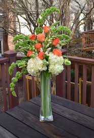 Place hydrangea vases in each corner or connecting area of your fences to provide accents in these areas. Tall Contemporary Arrangement With Hydrangeas Parrot Tulips Roses Bells Of Irelan Tall Vase Arrangements Fresh Flowers Arrangements Flower Vase Arrangements