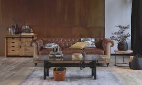 The round glass tabletop is crafted with nailhead trim on its dark edges. Glass And Metal Industrial Coffee Table L135 Garibaldi Maisons Du Monde