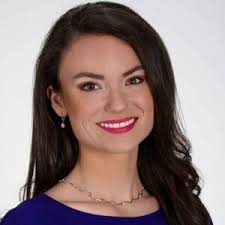 Football player pushes friend in wheelchair for marching band