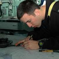 The amphibious dock landing ship USS Carter Hall (LSD 50) pulls alongside  the Military Sealift Command dry cargo and ammunition ship USNS Cesar  Chavez (T-AKE 14) for a replenishment-at-sea.