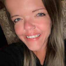 What is the animal in the photo, possibly a mountain lion or bobcat, with a  tail running along the back leg?