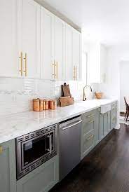 See more ideas about kitchen inspirations, kitchen design, kitchen remodel. Picture Of An Elegant And Shiny Kitchen With White And Sage Green Cabinetry A White Stone Countertop And Backsplash Gold Touches