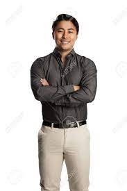 Attractive Calm Man Wearing A Grey Shirt And Beige Pants Standing Against A White Background Confident And Satisfied Stock Photo Picture And Royalty Free Image Image 76650822