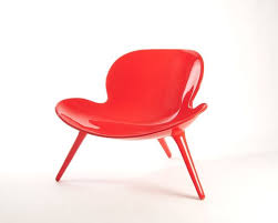 snuglette easy chair with curves expressing radiant jovial vibes made out of fiberglass with high gloss automotive paint