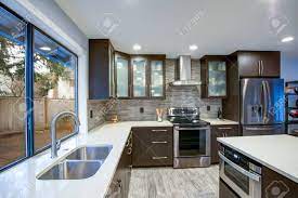 Light and dark shades of naturally stained wood grace the floors. Updated Contemporary Kitchen Room Interior With White Counters Stock Photo Picture And Royalty Free Image Image 95339573