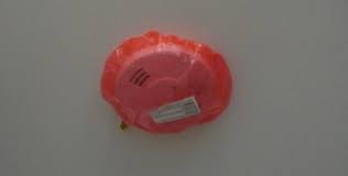 I would use some kind of plastic (like a freezer bag, fridge bag the best way to avoid a false alarm is to call your security company and have them put your system on test. Cover Smoke Detector With Plastic Bag