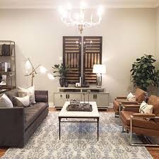Black And Gold Leather Couch Alice Lane Home Collection Black And Gold Art Gray Sofa Paired With Cognac Leather Chairs Grey Sofa Living Room Glamour Living Room Living Room Grey