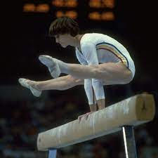• she was introduced to gymnastics at the age of 6 and trained under would be romanian national coach, bela karolyi. Nadia Comaneci