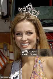 Shandi Finnessey, Miss USA 2004 poses with Firemen Phil Larimore,... News  Photo