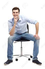Man sitting on a chair in front of a computer. Young Man Sitting In Chair Stock Photo Picture And Royalty Free Image Image 19155969