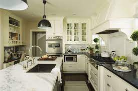 She chose white dove for the wall cabinets, which added an enormous amount of lightness to the room, and grounded the space with the black island. Martha O Hara Interiors White Kitchen Cabinets Paired With Black Granite Countertops And White Subway Tile Kitchen Design Home Kitchens Kitchen Remodel