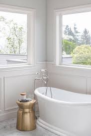 A Gold Accent Table Sits On Marble Staggered Floor Tiles Beside A Vintage Freestanding Bathtub Paired Wi Free Standing Bath Tub Luxury Bathroom Guest Bathrooms
