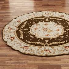 It features an abstract pattern with diamonds and wavy lines for a handmade aesthetic. Rose Aubusson Area Rugs