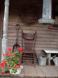 Old Chair Watering Can And Shovel On Front Porch Country Porch Old Chair Porch Decorating