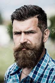 Check spelling or type a new query. Portrait Of Handsome Serious Unshaven Guy With Long Beard And Hendlebar Moustache In Checkered White And Light Blue Shirt Looking Forward Standing Outdoor Vertical Picture Stock Photo Picture And Royalty Free Image