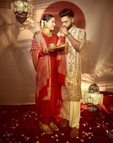 Hina Khan shared photos on Instagram celebrating her first Karwa Chauth after marrying Rocky Jaiswal in 2025. She looked stunning in a red suit paired with a Banarasi dupatta, heavy gold jewelry,