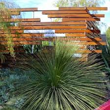 The warm cedar shades of the horizontal wood slats artfully complement the chrome frame and house numbers. Fence Styles 10 Popular Designs Today Bob Vila