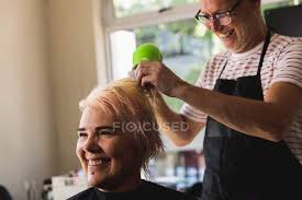Many salons do not like to show a fixed price as they believe it may there are few websites that show the service wise prices. Side View Close Up Of A Middle Aged Caucasian Male Hairdresser And A Young Caucasian Woman Having Her Hair Blow Dried In A Hair Salon Barber Female Stock Photo 307074660