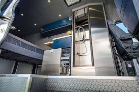 Some walls are designed with shelves to store bathroom amenities. Full Stainless Enclosured Shower Or Removable Shower Pan Outside Van Van Shower Van Conversion With Shower Camper Van Conversion Diy