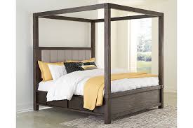 Functionally, the canopy and curtains keep the bed warmer, and screen it from light and sight. Dellbeck Queen Canopy Bed With 4 Storage Drawers Ashley Furniture Homestore