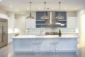Modern Beach Style Kitchen With Polished Concrete Floors White Cabinets And Blue Subway Tile Backsplash Coastal Kitchen Design Modern Kitchen Kitchen Styling