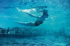 Underwater Swimmer With City In Background Communication Arts