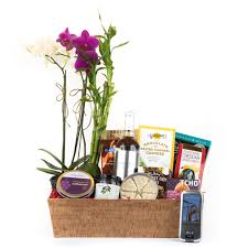 Our wine baskets are filled with the finest wines and paired with complementary creamy cheese and savory snacks to delight and surprise someone special! Flower Gift Basket