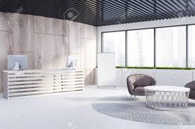 When potential customers or visitors enter the premises of our company, the first thing they see is the reception area and reception staff. Wooden Office Lobby With A Reception Desk A Round Carpet With A Coffee Table And Armchairs On It And Loft Windows A Banner In The Corner 3d Rendering Mock Up Stock Photo