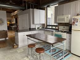Loft Style Kitchen With Tile And Hardwood Floors Exposed Brick Exposed Ductowrk Exposed Wood Bea Black Granite Countertops Kitchen Styling Gorgeous Kitchens