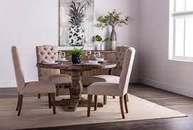 The table is distressed markings throughout. Caden Round Dining Table Living Spaces