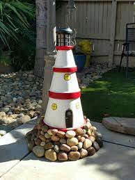 Handmade lighthouse ideas for a base to sit on / rock base / well cover. 46 Lighthouse Homemade Ideas Clay Pot Lighthouse Lighthouse Crafts Lighthouse