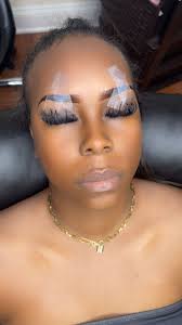 Brown cat eye makeup look with lashes and gloss