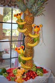 A simple fruit display for a small family that makes use of vertical space. Pineapple Tree Centerpiece With Fruit Monkeys Pineapple Tree Centerpieces Fruit Display Fruit Art